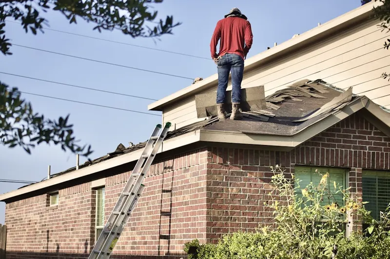 Professional roofer working on a residential roof in Harvard Place - Eastlawn